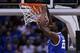 INDIANAPOLIS, IN - MARCH 30: Alex Poythress #22 of the Kentucky Wildcats dunks the ball over Caris LeVert #23 of the Michigan Wolverines in the first half during the midwest regional final of the 2014 NCAA Men's Basketball Tournament at Lucas Oil Stadium