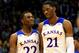 LAWRENCE, KS - NOVEMBER 22: Andrew Wiggins #22 of the Kansas Jayhawks talks with Joel Embiid #21 as they walk onto the floor after a timeout during the game against the Towson Tigers at Allen Fieldhouse on November 22, 2013 in Lawrence, Kansas. (Photo by