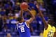 INDIANAPOLIS, IN - MARCH 30: Aaron Harrison #2 of the Kentucky Wildcats shoots the game winning shot late against Caris LeVert #23 of the Michigan Wolverines during the midwest regional final of the 2014 NCAA Men's Basketball Tournament at Lucas Oil Stad