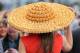 LIVERPOOL, ENGLAND - APRIL 04: A woman arrives for Ladies Day in a hat made from mini cheddars at Aintree Racecourse on April 4, 2014 in Liverpool, England. (Photo by Alex Livesey/Getty Images)