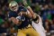 SOUTH BEND, IN - NOVEMBER 02: Troy Niklas #85 of the Notre Dame Fighting Irish catches a first down pass in front of Cody Peterson #53 of the Navy Midshipmen at Notre Dame Stadium on November 2, 2013 in South Bend, Indiana. Notre Dame defeated Navy 38-34.