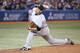 TORONTO, CANADA - APRIL 4: Masahiro Tanaka #19 of the New York Yankees delivers a pitch in the second inning during MLB game action against the Toronto Blue Jays on April 4, 2014 at Rogers Centre in Toronto, Ontario, Canada. (Photo by Tom Szczerbowski/Get