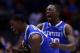 INDIANAPOLIS, IN - MARCH 28: Alex Poythress #22 and Julius Randle #30 of the Kentucky Wildcats celebrate defeating the Louisville Cardinals 74 to 69 during the regional semifinal of the 2014 NCAA Men's Basketball Tournament at Lucas Oil Stadium on March