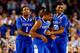 ARLINGTON, TX - APRIL 05: James Young #1, Aaron Harrison #2, and Marcus Lee #00 of the Kentucky Wildcats react during the NCAA Men's Final Four Semifinal against the Wisconsin Badgers at AT&T Stadium on April 5, 2014 in Arlington, Texas. (Photo by Tom Pe