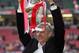 CARDIFF, UNITED KINGDOM - MAY 21: Arsenal Manager, Arsene Wenger holds aloft the trophy after winning the FA Cup Final between Arsenal and Manchester United 5-4 on penalty's at The Millennium Stadium on May 21, 2005 in Cardiff, Wales. (Photo by Ross Kin