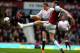 LONDON, ENGLAND - APRIL 06: Jordan Henderson of Liverpool and Andy Carroll of West Ham compete for the ball during the Barclays Premier League match between West Ham United and Liverpool at Boleyn Ground on April 6, 2014 in London, England. (Photo by Mi