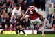 LONDON, ENGLAND - APRIL 06: James Tomkins of West Ham handles the ball whilst defending against Luis Suarez of Liverpool to concede a penalty to Liverpool during the Barclays Premier League match between West Ham United and Liverpool at Boleyn Ground on