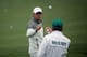 AUGUSTA, GA - APRIL 07: Rory McIlroy of Northern Ireland catches a golf ball from caddie J.P. Fitzgerald during a practice round prior to the start of the 2014 Masters Tournament at Augusta National Golf Club on April 7, 2014 in Augusta, Georgia. (Photo