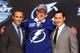 PITTSBURGH, PA - JUNE 22: Slater Koekkoek (C), tenth overall pick by the Tampa Bay Lightning, poses on stage with general manager Steve Yzerman (L) and team representatives during Round One of the 2012 NHL Entry Draft at Consol Energy Center on June 22,