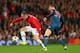 MANCHESTER, ENGLAND - APRIL 01: Toni Kroos of Bayern Muenchen marshalls Wayne Rooney of Manchester United during the UEFA Champions League Quarter Final first leg match between Manchester United and FC Bayern Muenchen at Old Trafford on April 1, 2014 in