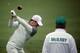 AUGUSTA, GA - APRIL 07: (L-R) Rory McIlroy of Northern Ireland hits a shot as his caddie, J. P. Fitzgerald, looks on during a practice round prior to the start of the 2014 Masters Tournament at Augusta National Golf Club on April 7, 2014 in Augusta, Georg