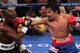LAS VEGAS, NV - JUNE 09: (R-L) Manny Pacquiao lands a right to the head of Timothy Bradley during their WBO welterweight title fight at MGM Grand Garden Arena on June 9, 2012 in Las Vegas, Nevada. (Photo by Jeff Bottari/Getty Images)