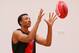 MELBOURNE, AUSTRALIA - FEBRUARY 14: Young Australian basketball player Dante Exum marks the ball after being presented a jumper by Joe Daniher of the Bombers during an Essendon Bombers AFL media session at True Value Solar Centre on February 14, 2014 in
