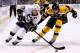 BOSTON, MA - DECEMBER 07: Sidney Crosby #87 of the Pittsburgh Penguins carries the puck in front of a stickless Zdeno Chara #33 of the Boston Bruins in the second period during the game at TD Garden on December 7, 2013 in Boston, Massachusetts. (Photo b