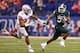 INDIANAPOLIS, IN - DECEMBER 07: Jeremy Langford #33 of the Michigan State Spartans runs against the defense of Joshua Perry #37 of the Ohio State Buckeyes during the Big Ten Conference Championship game at Lucas Oil Stadium on December 7, 2013 in Indiana