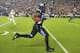 Oct 17, 2013; Chapel Hill, NC, USA; North Carolina Tar Heels tight end Eric Ebron (85) runs for a touchdown as Miami Hurricanes defensive back Antonio Crawford (21) defends in the first quarter at Kenan Memorial Stadium. Mandatory Credit: Bob Donnan-USA T