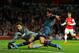 LONDON, ENGLAND - FEBRUARY 19: Lukasz Fabianski of Arsenal dives to makes a save from Claudio Pizarro of Bayern Muenchen during the UEFA Champions League Round of 16 first leg match between Arsenal and FC Bayern Muenchen at Emirates Stadium on February 1