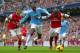 MANCHESTER, ENGLAND - DECEMBER 14: Yaya Toure of Manchester City is closed down by Mathieu Flamini and Bacary Sagna of Arsenal during the Barclays Premier League match between Manchester City and Arsenal at Etihad Stadium on December 14, 2013 in Manches