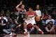 WASHINGTON, DC - FEBRUARY 5: Trevor Ariza #1 of the Washington Wizards drives against Marco Belinelli #3 of the San Antonio Spurs at the Verizon Center on February 5, 2014 in Washington, DC. NOTE TO USER: User expressly acknowledges and agrees that, by do