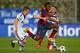 NYON, SWITZERLAND - APRIL 11: Adama Traore of FC Barcelona (C) competes for the ball with Miles Mueller (L) and Pascal Itter (R) of FC Schalke 04 during the UEFA Youth League Semi Final match between Schalke 04 and FC Barcelona at Colovray Stadion on Apri
