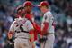 DENVER, CO - APRIL 04: Pitching coach Mike Harkey #22 of the Arizona Diamondbacks visits pitcher Brad Ziegler #29 of the Arizona Diamondbacks on the mound as catcher Miguel Montero #26 of the Arizona Diamondbacks looks on against the Colorado Rockies dur