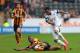 HULL, ENGLAND - APRIL 05: Hull City's Maynor Figueroa (grounded) and Swansea City's Jonathan de Guzman compete or the ball during the Barclays Premier League match between Hull City and Swansea City at KC Stadium on April 5, 2014 in Hull, England. (Phot