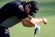 Apr 11, 2014; Augusta, GA, USA; Rory McIlroy reacts after hitting into the azaleas on the 13th hole during the second round of the 2014 The Masters golf tournament at Augusta National Golf Club. Mandatory Credit: Michael Madrid-USA TODAY Sports
