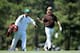 AUGUSTA, GA - APRIL 12: Miguel Angel Jimenez of Spain walks with his caddie Clifford Botha in the 14th fairway during the third round of the 2014 Masters Tournament at Augusta National Golf Club on April 12, 2014 in Augusta, Georgia. (Photo by David Can