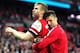 LONDON, ENGLAND - APRIL 12: Per Mertesacker and Olivier Giroud of Arsenal celebrate victory during the FA Cup Semi-Final match between Wigan Athletic and Arsenal at Wembley Stadium on April 12, 2014 in London, England. (Photo by Mike Hewitt/Getty Images