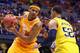 INDIANAPOLIS, IN - MARCH 28: Jarnell Stokes #5 of the Tennessee Volunteers drives to the basket against Jordan Morgan #52 of the Michigan Wolverines in the first half during the regional semifinal of the 2014 NCAA Men's Basketball Tournament at Lucas Oil