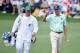 AUGUSTA, GA - APRIL 13: Matt Kuchar of the United States waves to the gallery as he walks onto the second green with his caddie Lance Bennett during the final round of the 2014 Masters Tournament at Augusta National Golf Club on April 13, 2014 in Augusta