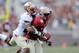 TALLAHASSEE, FL - APRIL 12: P.J. Williams #26 of the Gold team strips a ball from Jesus Wilson #3 of the Garnet team during Florida State's Garnet and Gold spring game at Doak Campbell Stadium on April 12, 2014 in Tallahassee, Florida. (Photo by Stacy R