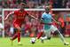 LIVERPOOL, ENGLAND - APRIL 13: Raheem Sterling of Liverpool competes with Fernandinho of Manchester City during the Barclays Premier League match between Liverpool and Manchester City at Anfield on April 13, 2014 in Liverpool, England. (Photo by Alex Li