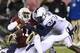 Nov 23, 2013; Philadelphia, PA, USA; Connecticut Huskies linebacker Yawin Smallwood (33) assists defensive end Reuben Frank (47) in a tackle of Temple Owls quarterback P.J. Walker (11) during the third quarter at Lincoln Financial Field. UCONN defeated Te