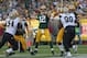 GREEN BAY, WI - SEPTEMBER 30: Aaron Rodgers #12 of the Green Bay Packers passes under pressure from Cameron Jordan #94 and Sedrick Ellis #98 of the New Orleans Saints at Lambeau Field on September 30, 2012 in Green Bay, Wisconsin. The Packers defeated the