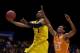 INDIANAPOLIS, IN - MARCH 28: Glenn Robinson III #1 of the Michigan Wolverines shoots the ball against Derek Reese #23 of the Tennessee Volunteers during the regional semifinal of the 2014 NCAA Men's Basketball Tournament at Lucas Oil Stadium on March 28,