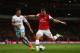 LONDON, ENGLAND - APRIL 15: Lukas Podolski of Arsenal beats James Tomkins of West Ham United as he scores their third goal during the Barclays Premier League match between Arsenal and West Ham United at Emirates Stadium on April 15, 2014 in London, Engla