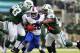 EAST RUTHERFORD, NJ - SEPTEMBER 22: Running back C.J. Spiller #28 of the Buffalo Bills attempts to break free from defensive tackle Kenrick Ellis #93 and defensive end Quinton Coples #98 of the New York Jets during the second quarter in a game at MetLife