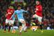 MANCHESTER, ENGLAND - MARCH 25: David Silva of Manchester City competes with Wayne Rooney of Manchester United during the Barclays Premier League match between Manchester United and Manchester City at Old Trafford on March 25, 2014 in Manchester, England