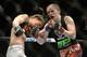 Apr 16, 2014; Quebec City, Quebec, Canada; Sarah Kaufman ( red gloves) Victoria, BC,Canada take a hit Leslie Smith (blue gloves), Pleasant Hiil, CA during their women's bantamweight bout at Colisee Pepsi. Mandatory Credit: Eric Bolte-USA TODAY Sports