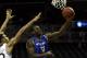 NEW YORK, NY - DECEMBER 21: Javon McCrea #12 of the Buffalo Bulls drives to the basket past Ashton Pankey #30 of the Manhattan Jaspers during the Brooklyn Hoops Holiday Invitational at Barclays Center on December 21, 2013 in the Brooklyn borough of New Y
