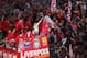 LIVERPOOL, ENGLAND - MAY 26: Captain Steven Gerrard holds the trophy aloft as the Liverpool team ride on an open top bus through a mass of fans as they arrive at St. George's Hall during the Liverpool Champions League Victory Parade on May 26, 2005 in Li