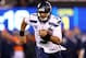 EAST RUTHERFORD, NJ - FEBRUARY 02: Quarterback Russell Wilson #3 of the Seattle Seahawks runs the ball against the Denver Broncos during Super Bowl XLVIII at MetLife Stadium on February 2, 2014 in East Rutherford, New Jersey. (Photo by Elsa/Getty Images