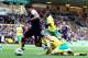 NORWICH, ENGLAND - SEPTEMBER 29: Luis Suarez of Liverpool rounds Michael Turner of Norwich City to setup a goal for team-mate Nuri Sahin during the Barclays Premier League match between Norwich City and Liverpool at Carrow Road on September 29, 2012 in