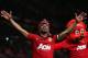 MANCHESTER, ENGLAND - APRIL 22: Patrice Evra of Manchester United celebrates victory and winning the Premier League title with mascot Fred the Red after the Barclays Premier League match between Manchester United and Aston Villa at Old Trafford on April