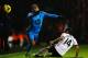 LONDON, ENGLAND - DECEMBER 04: Aaron Lennon (L) of Tottenham Hotspur is challenged by Giorgos Karagounis (R) of Fulham during the Barclays Premier League match between Fulham and Tottenham Hotspur at Craven Cottage on December 4, 2013 in London, England.