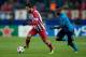 MADRID, SPAIN - DECEMBER 11: Arda Turan (L) of Atletico de Madrid competes for the ball with Silvestre Varela (R) of FC Porto during the UEFA Champions League Group G match at Vicente Calderon Stadium on December 11, 2013 in Madrid, Spain. (Photo by Go