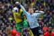 NORWICH, ENGLAND - APRIL 20: Simon Mignolet of Liverpool fails to punch the ball clear during the Barclays Premier League match between Norwich City and Liverpool at Carrow Road on April 20, 2014 in Norwich, England. (Photo by Michael Regan/Getty Images