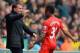NORWICH, ENGLAND - APRIL 20: Raheem Sterling of Liverpool celebrates scoring the opening goal with Manager Brendan Rodgers of Liverpool during the Barclays Premier League match between Norwich City and Liverpool at Carrow Road on April 20, 2014 in Norwic