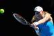MELBOURNE, AUSTRALIA - JANUARY 14: Johanna Larsson of Sweden plays a backhand in her first round match against Victoria Azarenka of Belarus during day two of the 2014 Australian Open at Melbourne Park on January 14, 2014 in Melbourne, Australia. (Photo